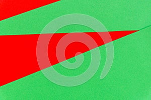 Abstract bright red on green paper background.