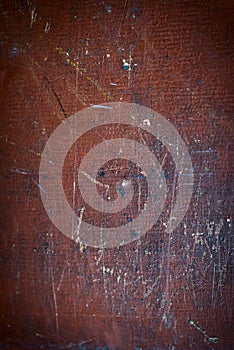 Abstract brown texture with stains, scratches and scuffs with age. Vignetting at the edges of the surface. Multicolored scuff and photo