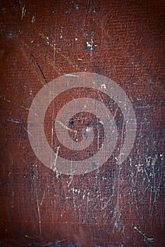 Abstract brown texture with stains, scratches and scuffs with age. Vignetting at the edges of the surface. Multicolored scuff and