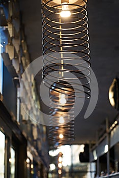 Abstract cafe bar restaurant interior background with ceiling wire chandelier lamps