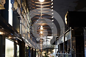 Abstract cafe bar restaurant interior background with ceiling wire chandelier lamps