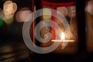 Abstract candle lantern light on wood table in blur bokeh pub re