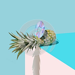Abstract cd and pineapple concept. Arrangement made with pastel, baby blue and beige background