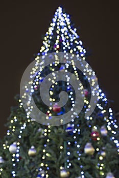 Abstract christmas background with christmas tree with decorations, defocused bokeh lights