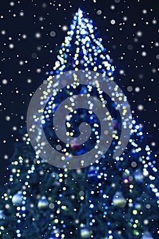 Abstract christmas background with christmas tree with decorations, defocused bokeh lights