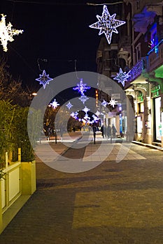 Abstract Christmas background with defocused effect and film grain effet of the european road with christmas tree