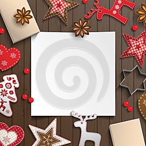 Abstract christmas background, white sheet of paper lying among small scandinavian styled decorations on wooden desk