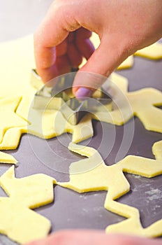 Abstract Christmas food background with cookies molds and flour. Baking Christmas cookies - table, cookie cutters and cookies.
