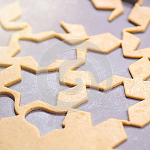 Abstract Christmas food background with cookies molds and flour. Baking Christmas cookies - table, cookie cutters and cookies.