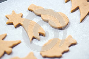 Abstract Christmas food background with cookies molds and flour. Baking Christmas cookies - table, cookie cutters and cookies.