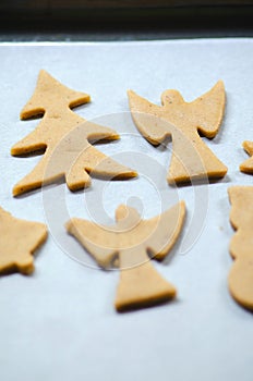 Abstract Christmas food background with cookies molds and flour. Baking Christmas cookies - table, cookie cutters and cookies.