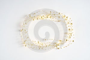 Abstract Christmas frame made of led garland lights on a light background. Blurred glowing garland of light bulbs