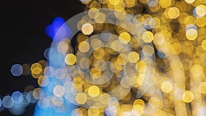 Abstract Christmas tree and New Year garland multicolored neon ights close-up. Blurred bokeh. Dark background