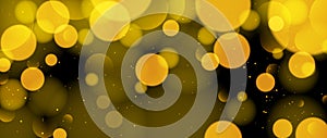 Abstract circle bokeh wallpaper. Gold yellow blur effect on black background. Shiny golden light sparkle texture. Blurry