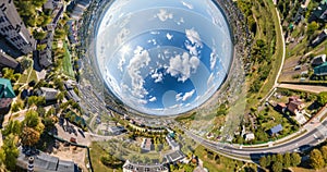 abstract circular curvature of surface of earth and twisting of sky into blue sphere inside urban infrastructure