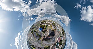 abstract circular curvature of surface of earth and twisting of sky into blue sphere inside urban infrastructure