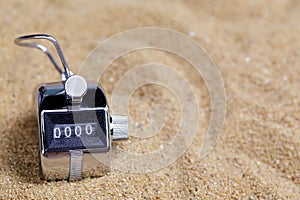 Abstract Classic metallic clicker on sea sand background