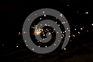 Abstract close-up image of blurred sparks and smoke from arc welding with bokeh effect