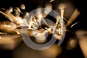 Abstract close-up image of blurred sparks and smoke from arc welding with bokeh effect