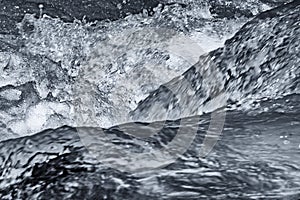 Abstract close-up of the water and waves of a river in black and white