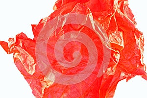 An abstract closeup of crushed paper in red .