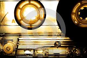 Abstract Closeup of See Through Cassette Tape with Dramatic Sepia Toned Lighting