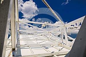 Abstract closeup view of old rusty metal frame, carcass against dark blue sky background