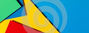 Abstract color papers geometry flat lay composition background with blue, yellow, green and red color tones