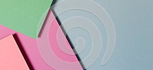 Abstract color papers geometry flat lay composition banner background with green, pink, purple, blue color tones