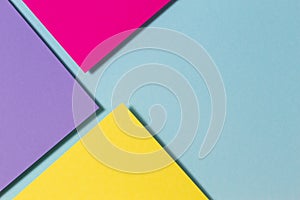 Abstract color papers geometry flat lay composition banner background with purple, yellow, magenta and blue color tones