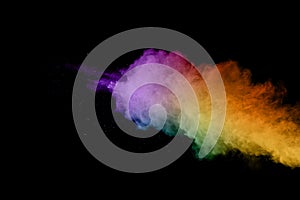 Abstract colored dust explosion on a black background.abstract powder splatted background,Freeze motion of color powder exploding/