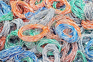 Abstract colorful background of electrical cables.  Random weaving of colored wire. Multicolored wires entangled in many hanks