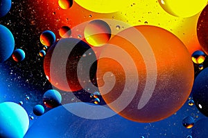 Abstract colorful background of oil circles. Oil in the water surface circles, water foam and oil bubbles.