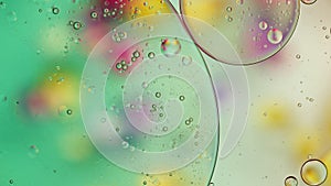 Abstract Colorful Food Oil Drops Bubbles and spheres Flowing on Water Surface, macro Videography