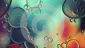 Abstract Colorful Food Oil Drops Bubbles and spheres Flowing on Water Surface, macro Videography