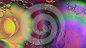 Abstract Colorful Food Oil Drops Bubbles and spheres Flowing on Water Surface, macro Videography