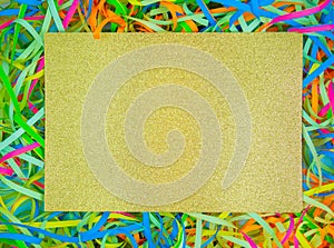 Abstract colorful holiday paper ribbons,gold sparkling paper copy space in middle.Celebration curly serpentine,event,fun