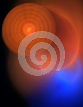 Circles and discs in bright orange over blue enlightened haziness. photo