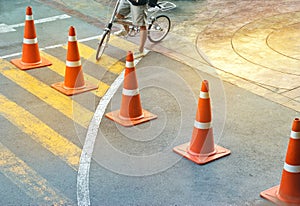 Abstract colorful traffic cones and bicycle man on the street, pastel and colorful concept