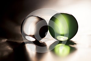 Abstract composition with beautiful, green and grey, transparent, round jelly balls on an aluminium foil with reflexions