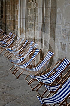 Abstract composition of blue and white deckchairs.