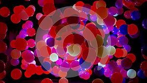 Abstract composition of colorful balls in air, which randomly light up and reflect in each other. Multicolored spheres