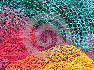 Abstract composition of mesh bags for fruit and vegetable closeup.