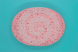 Abstract composition of pink sponge on blue background surface