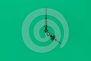 Abstract composition of very old and vintage black clockwise on green background surface