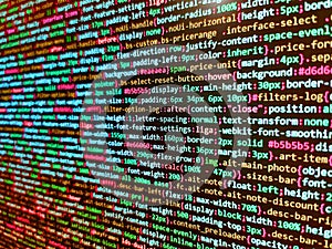 Abstract computer script source code. Programmer working in a software develop company office. Background of software developer