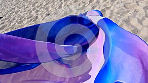 Abstract conceptual background. Scarf cloth fluttering in the wind over sand