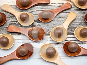 Abstract conceptual photo of chocolate balls on tea spoons