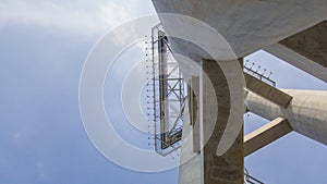 Abstract concrete constructure to the top with blue sky background