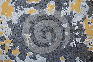 Abstract concrete and paint background with the yellow paint flacking